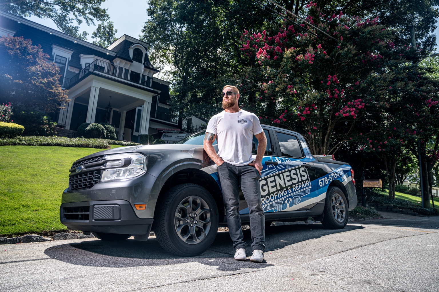 Steven Schmit beside the Genesis Roofing & Repair truck