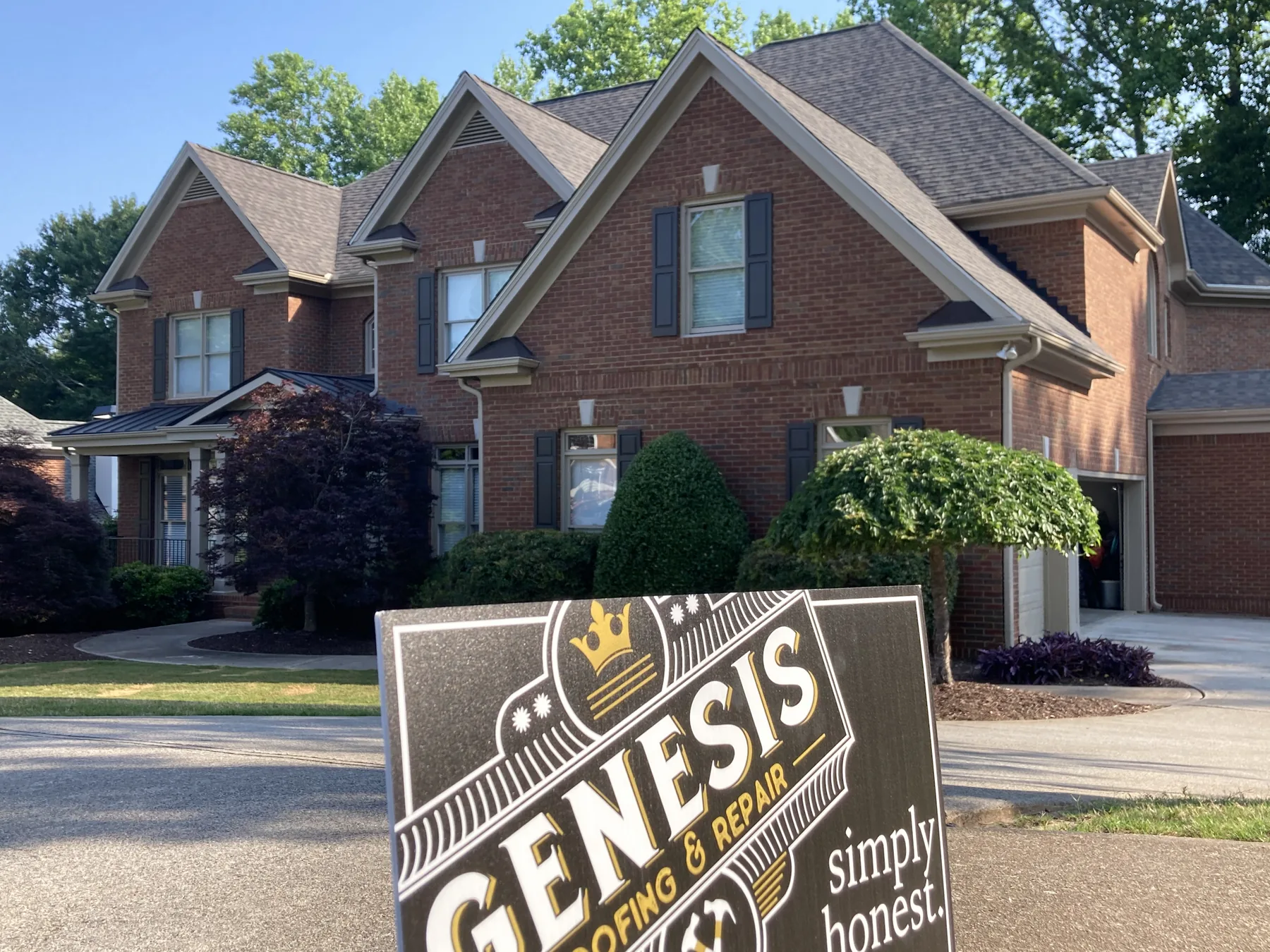 Completed shingle roof on a brick home